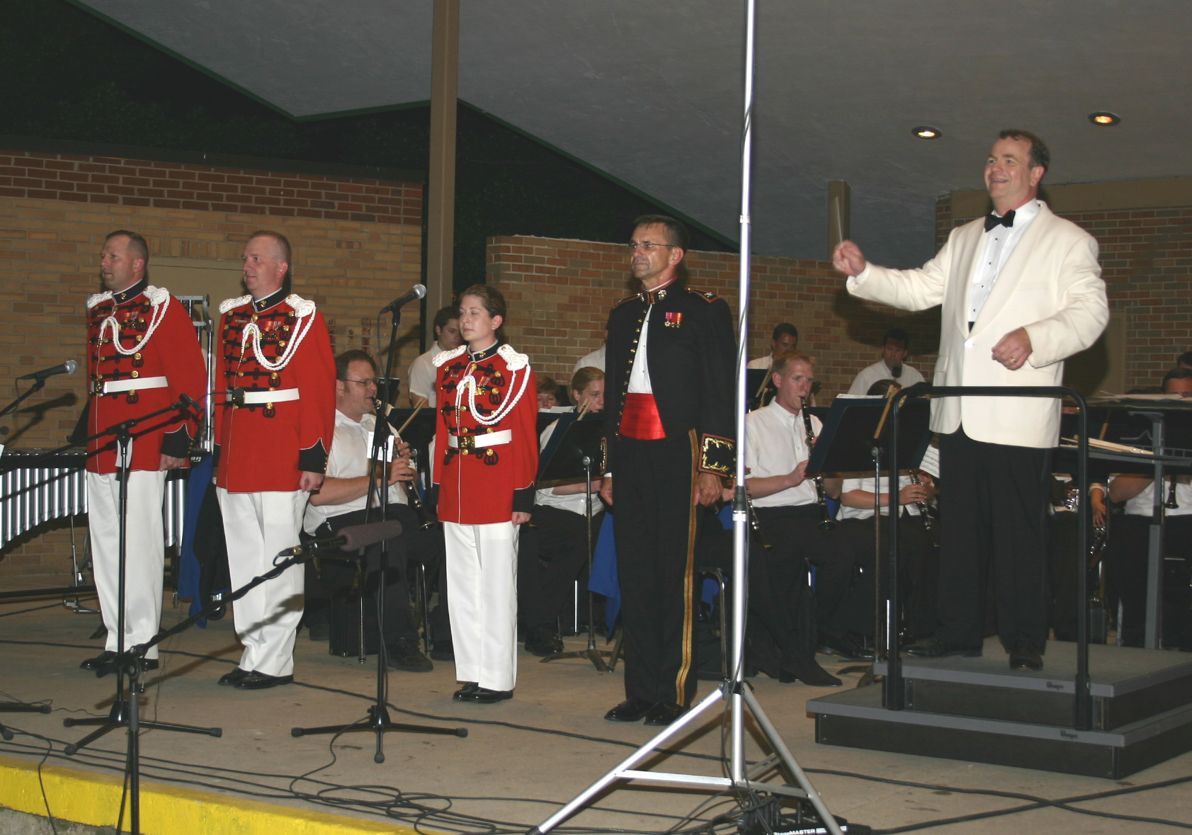  Col. Timothy Foley guest conducted the Wheaton Municipal Band. On that occassion, three former Wheaton Band members, also members of the President's Own United States Marine Band, came along. Roger Kantner (left), Jay Niepoetter, and Jennifer Marotta stand in uniform to Col. Foley's right.  