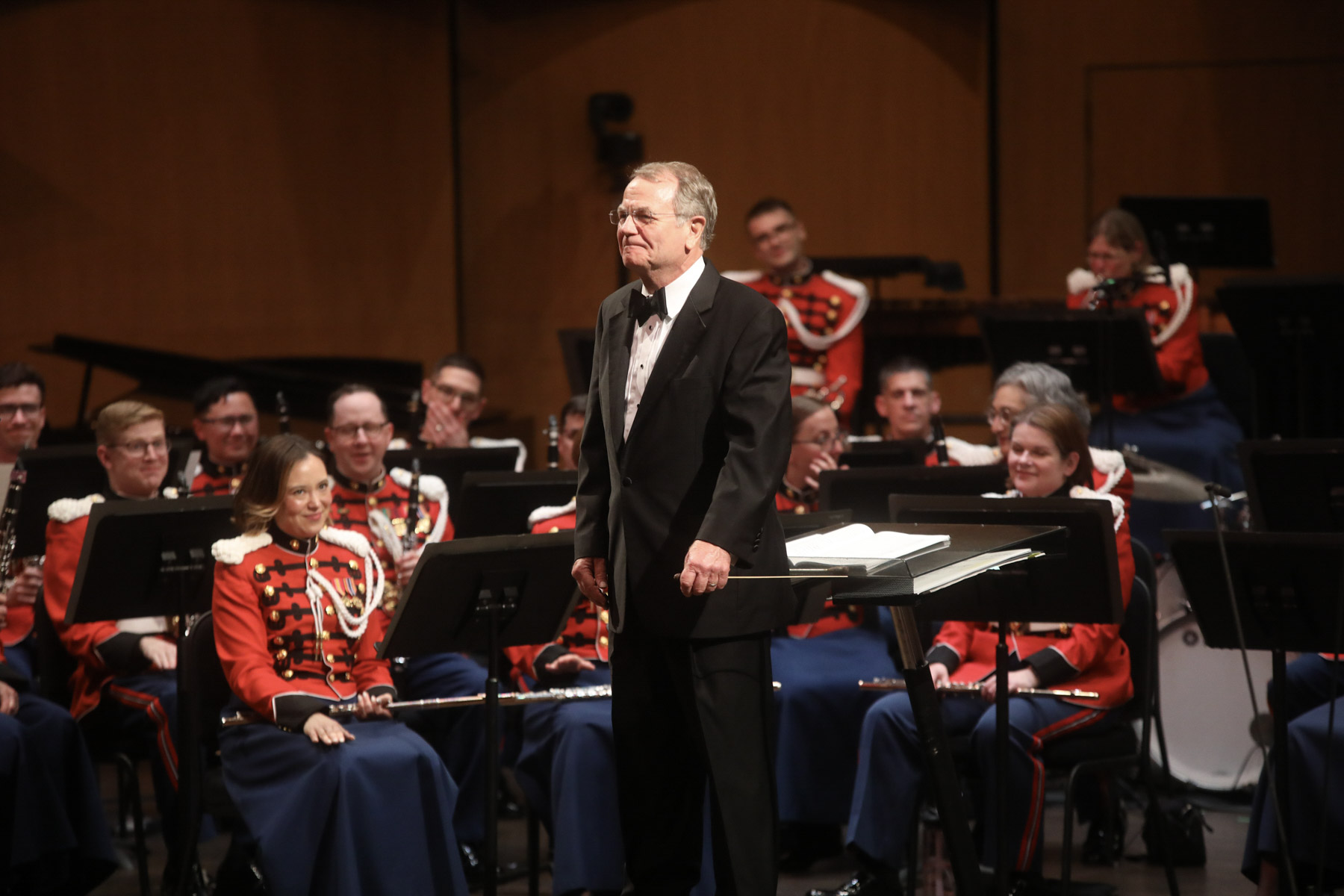  Dr. Moss stands in front of The President's Own United States Marine Band as guest conductor at the 89th annual American Bandmasters Association Convention. (March, 2024)  